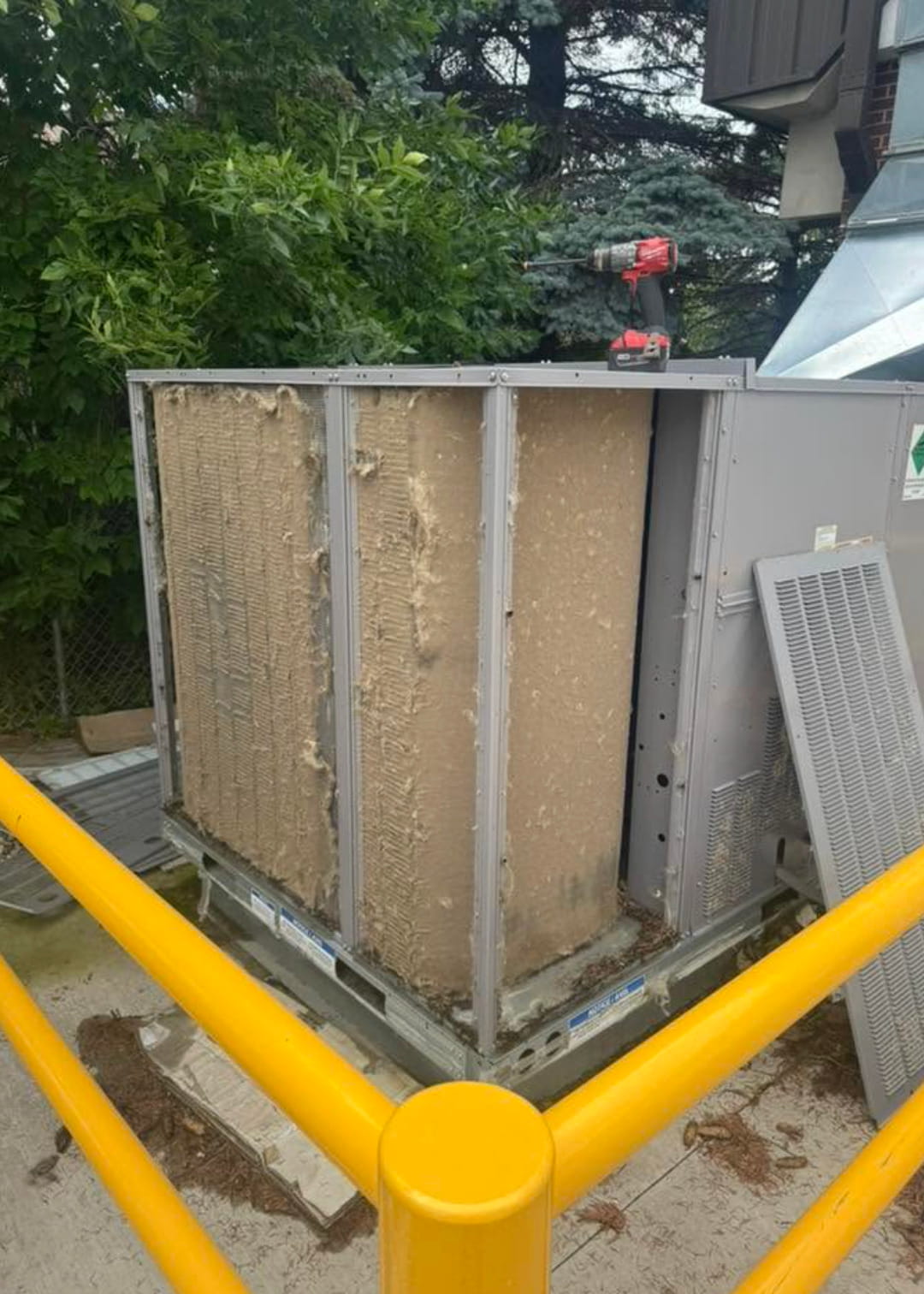 Commercial HVAC unit with panels removed for maintenance, cleaning, and system repair service.