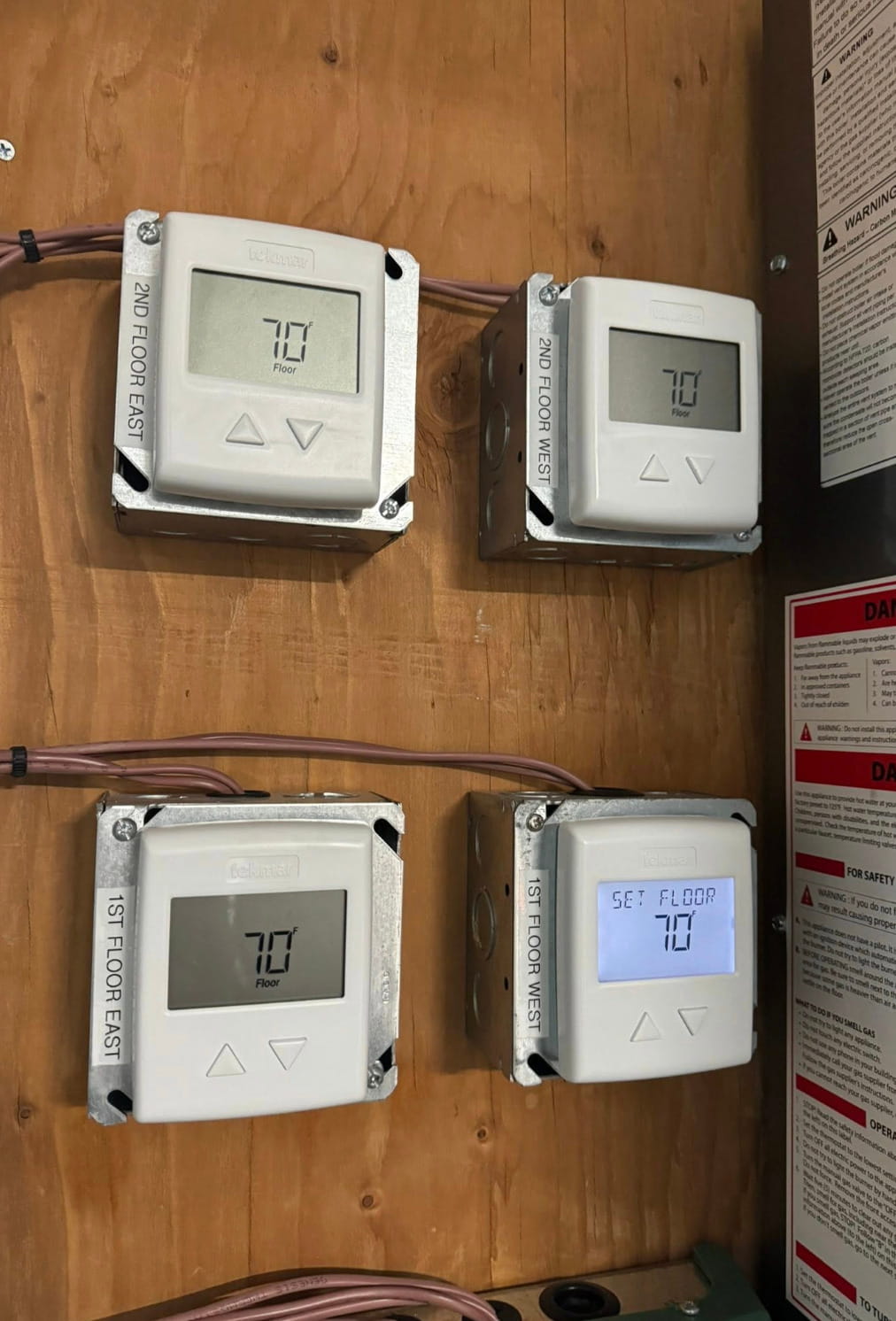 Multiple thermostat controls installed for separate floor zones to manage heating, cooling, and indoor comfort.