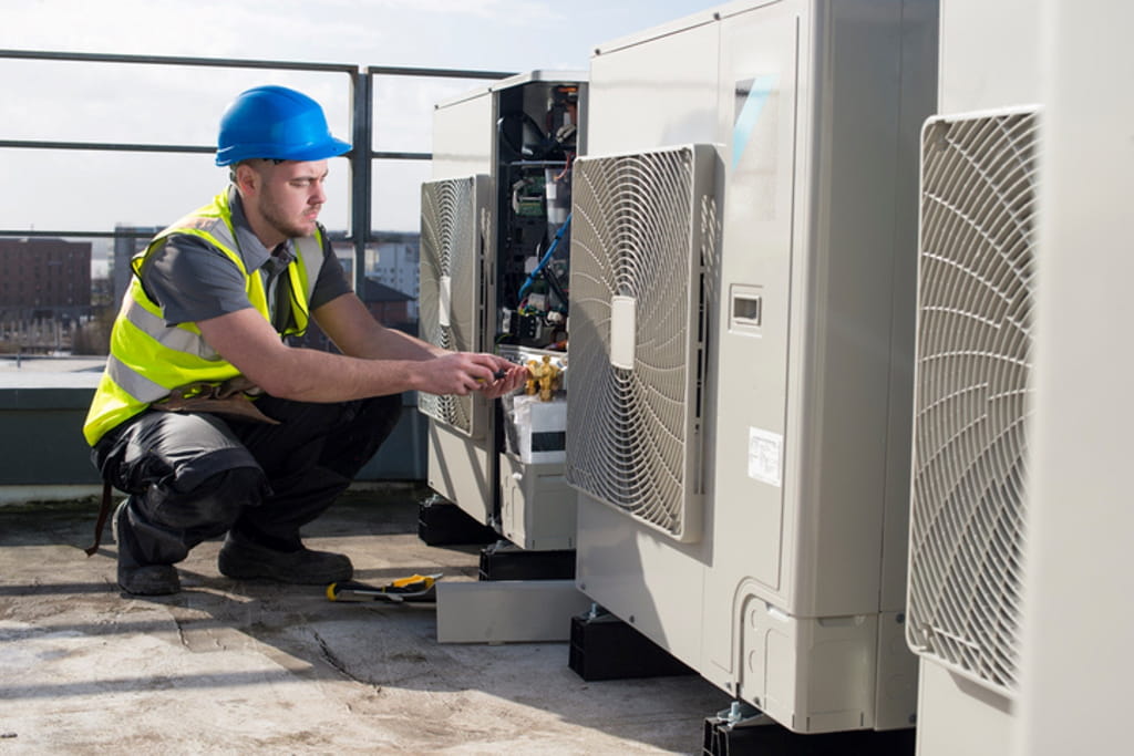 HVAC technician servicing rooftop heating and cooling units to improve system performance and reliability.