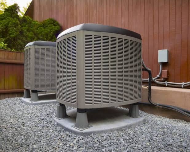 Two outdoor HVAC units installed beside a building, providing reliable cooling and efficient indoor comfort.