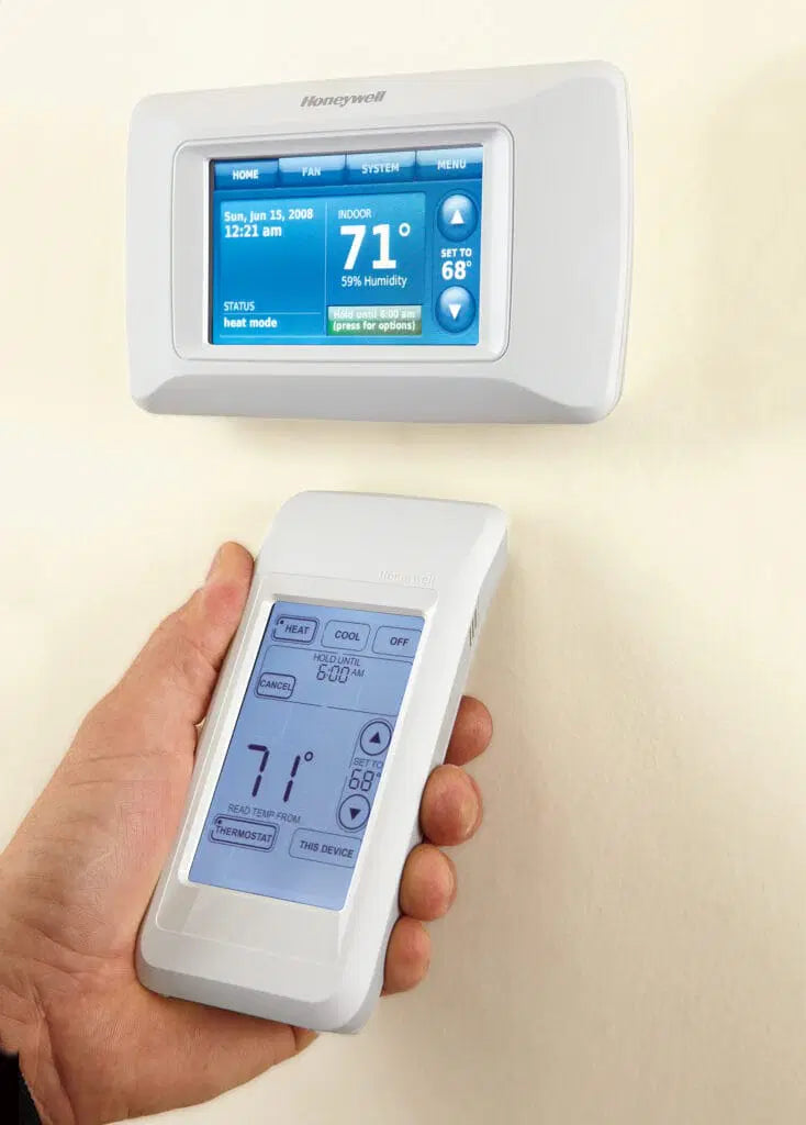 Smart thermostat and handheld control used to manage heating, cooling, humidity, and indoor comfort settings.
